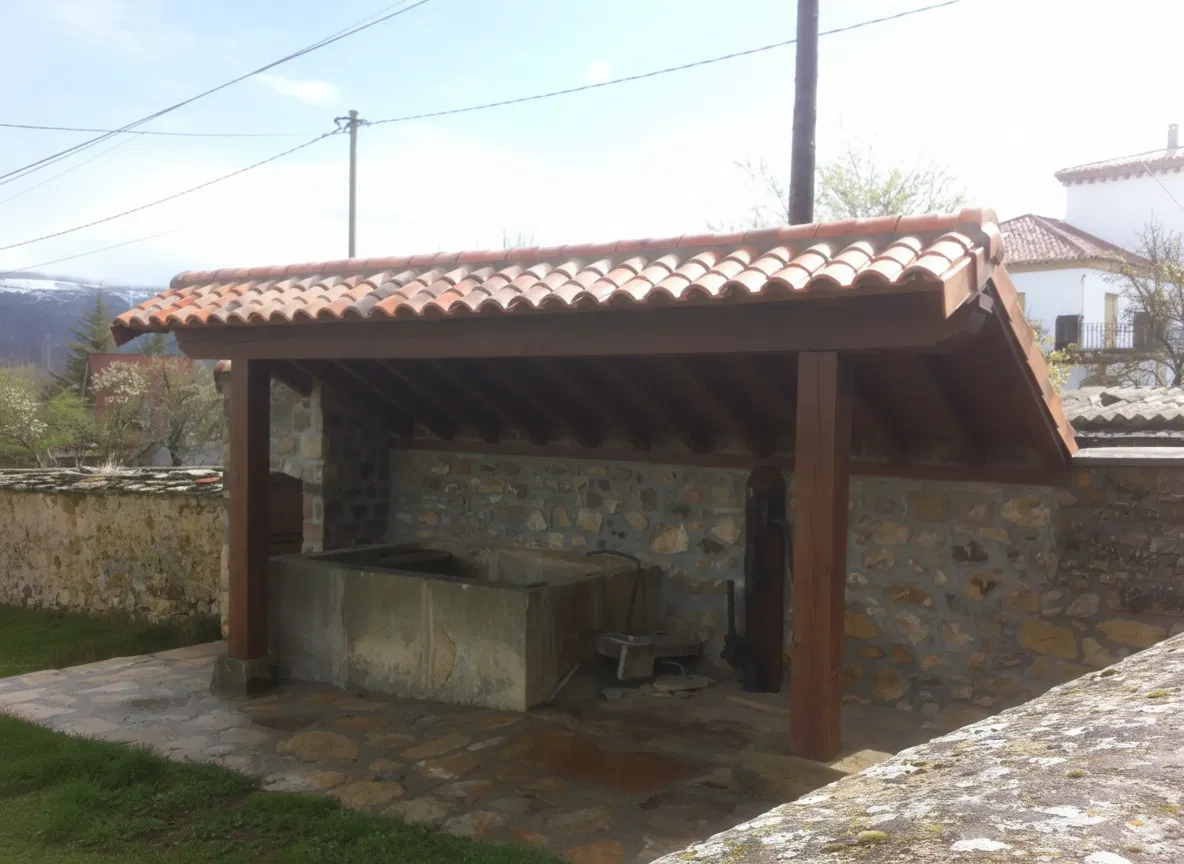 Porche con mucha caída adaptado a murete para la cubrición de un pilón.